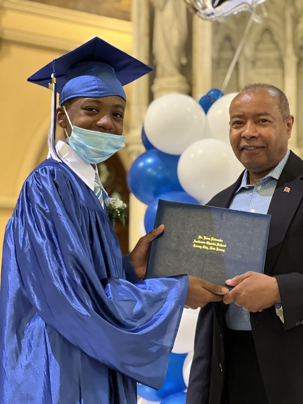 Principal Brewer gives graduates diplomas